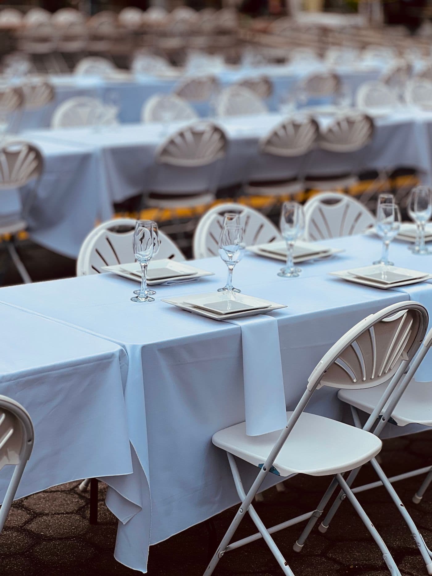 Rectangle folding tables set with white folding chairs
